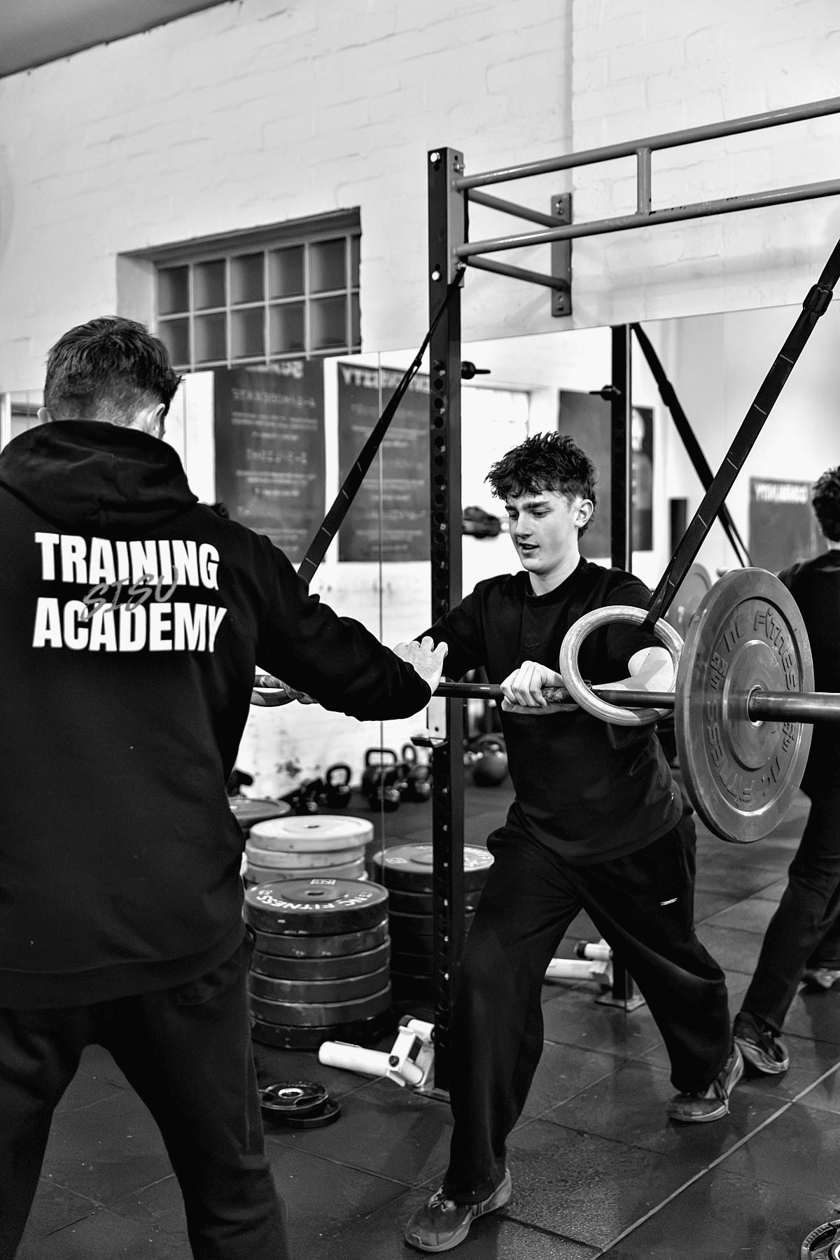 Ben coaching an athlete through a barbell lift